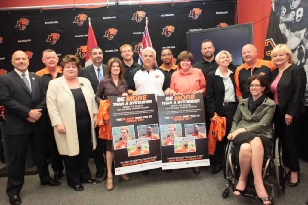 Celebrating the first two years of the Bystander program, EVA BC, the BC Lions. and government representatives.